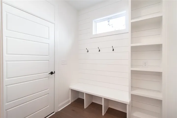 A well-appointed mudroom offers built-in storage and convenient hooks. Photos are not of subject property. Photos are of the same floorplan of a completed home.