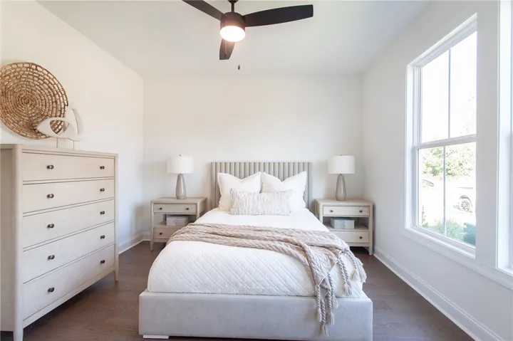 Well-lit sleeping quarters with rich hardwood floors and abundant natural light. Photos are not of subject property. Photos are of the same floorplan of a completed home.
