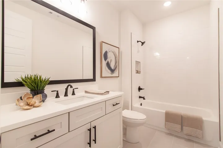 Modern fixtures and white subway tile create a serene and functional bathroom.Photos are not of subject property. Photos are of the same floorplan of a completed home.