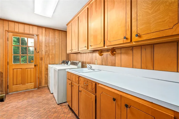 Spacious Laundry Room with Sink and Cabinetry
