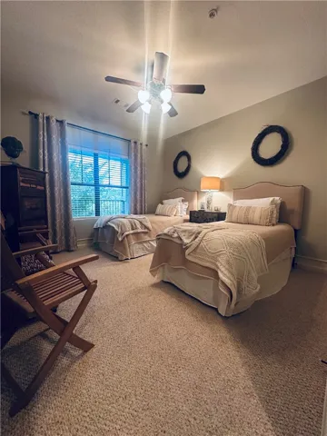 Well-lit and tranquil bedroom with comfortable sleeping arrangements and practical overhead lighting.
