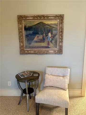 A quiet corner beckons with an inviting armchair and a charming accent table.