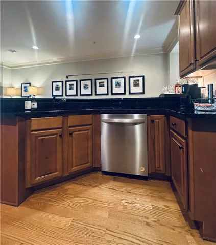 A well-appointed kitchen showcasing hardwood floors and rich wood cabinetry, offering both functionality and inviting warmth.