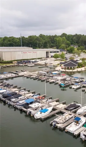 Boats nestled in slips at Harbor Pointe Marina, with a grand boat storage facility in the background.