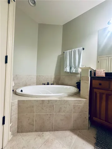 An inviting soaking tub awaits in this thoughtfully tiled bathroom.