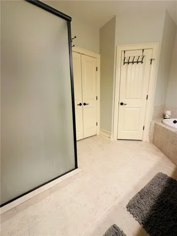 A well-appointed bathroom offers sleek tiled flooring and contemporary fixtures.