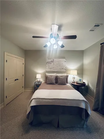 A comfortable bedroom features plush carpeting and a convenient closet.
