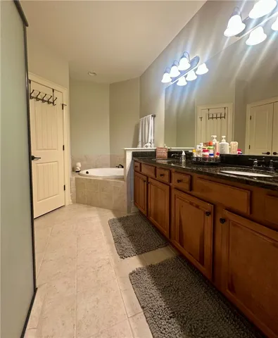 Granite counters and a jetted soaking tub create a luxurious bath retreat.