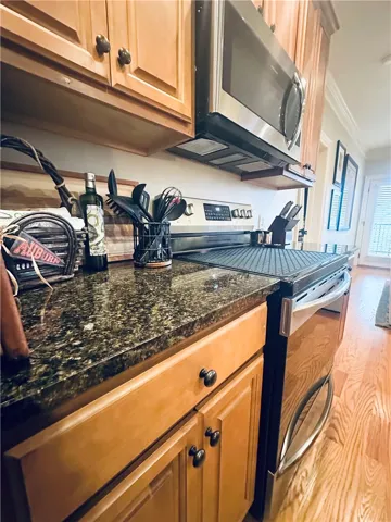 A well-appointed kitchen features rich wooden cabinetry and polished granite countertops.