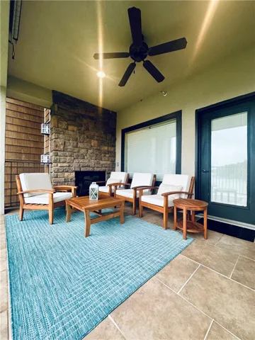 An inviting outdoor oasis with a fireplace and ample seating offers serene relaxation.