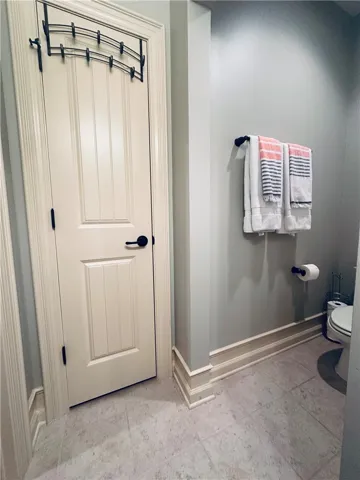 Clean and functional bathroom with neutral tile flooring.