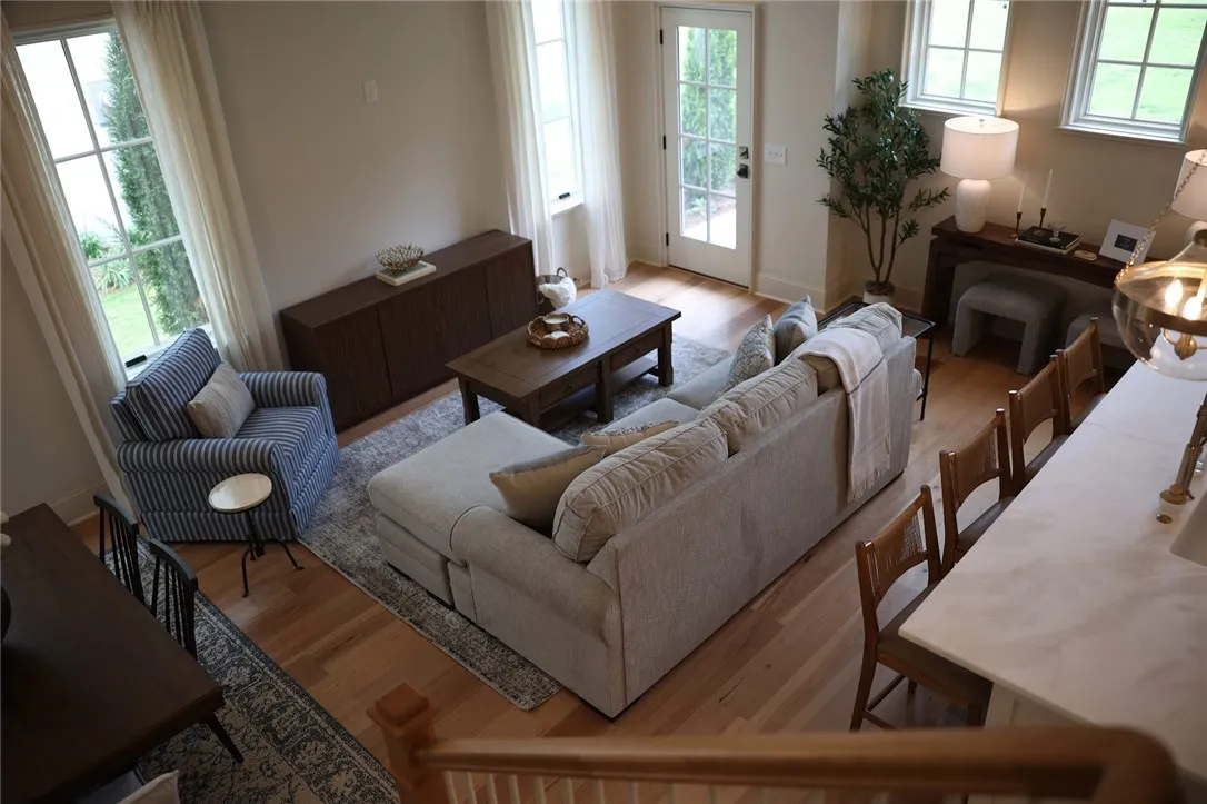 Rich hardwood floors complement an airy layout with multi-pane windows and private outdoor access.
