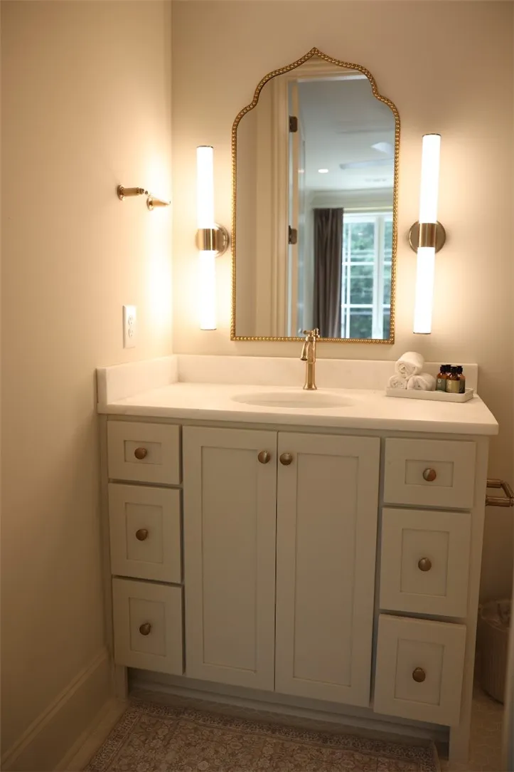 Elegant fixtures and clean lines detail a classic vanity alcove.