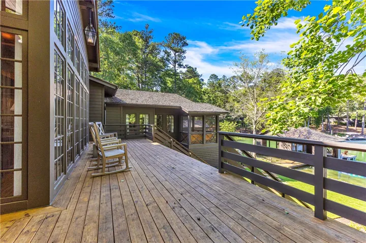 Enjoy tranquil water views from this spacious, elevated wooden deck perfect for relaxation.