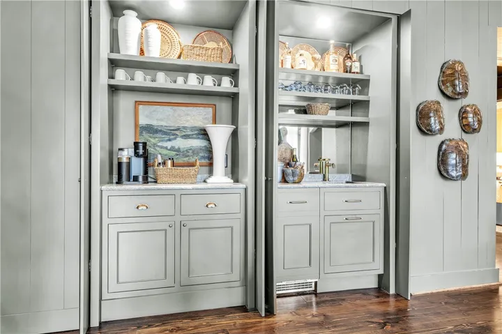 Functional custom built-ins offer versatile storage and a convenient wet bar.