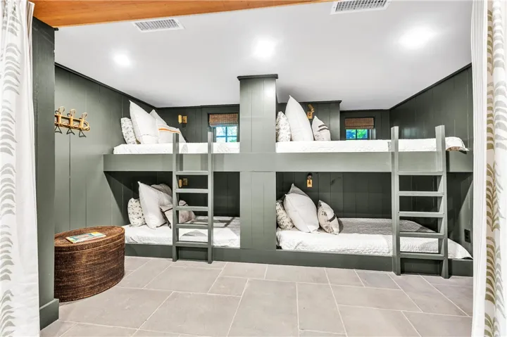 Custom-built bunk beds offer clever sleeping arrangements in this inviting space.