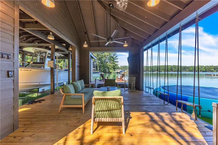 A boat house offers comfortable seating and swings, ideal for lakeside leisure.