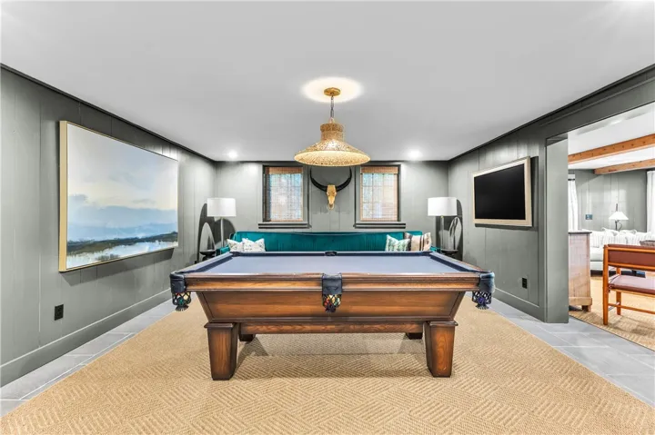 A dedicated game room featuring a prominent billiard table offers leisure and entertainment.