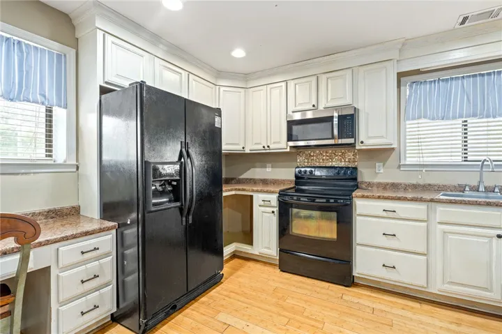 A functional culinary space boasts ample cabinet storage and essential appliances.