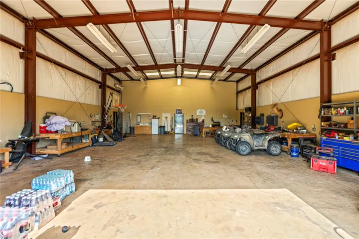 A spacious workshop with a robust metal framework, ideal for storage or projects.