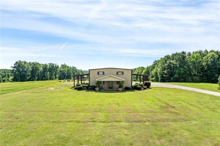 A spacious front yard envelops this distinctive home, offering abundant outdoor living.