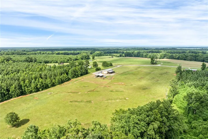 Vast green fields and abundant woodlands create an idyllic rural setting.