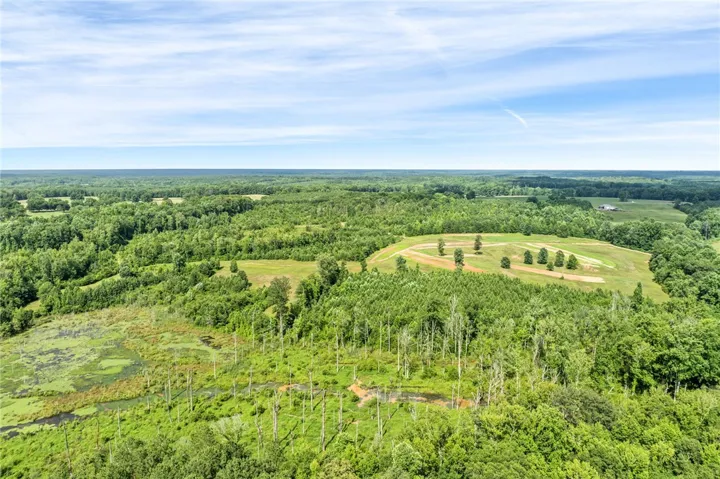 A sprawling rural landscape offers abundant trees, open land, and wetlands.
