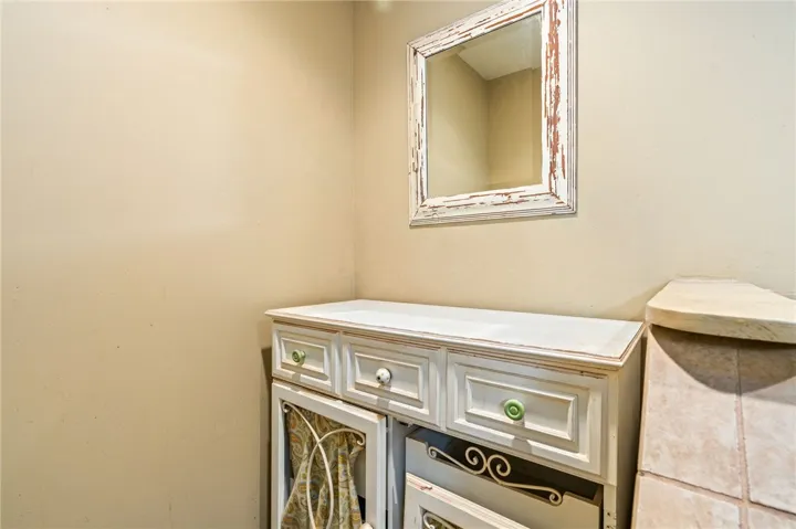 A charming weathered mirror hangs above a console, perfect for entryway essentials.
