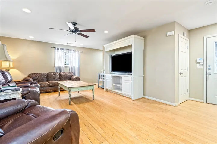 Wood flooring and neutral tones define this inviting living room.