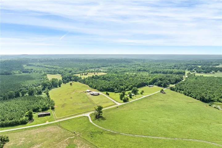 Vast green acreage unfolds under an endless sky, perfect for a secluded estate.