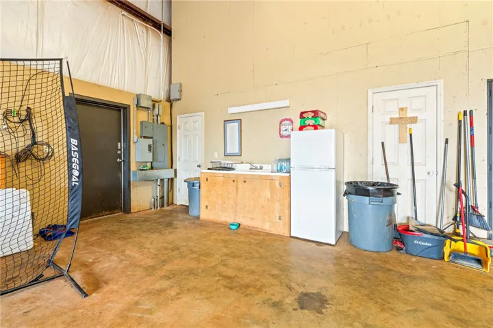 A versatile utility space with concrete flooring and ample room for various activities and storage.