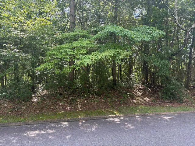 A tranquil wooded lot offering a private setting.