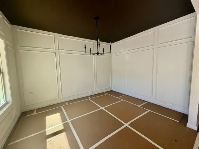 Elegant wall paneling defines this formal dining space, awaiting your personal touch.