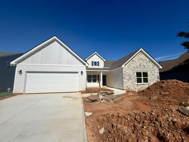 A newly constructed home combines durable siding and elegant stone facade for appealing curb appeal.