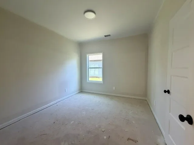 Ready for personalization, this bedroom offers clean lines and natural illumination.