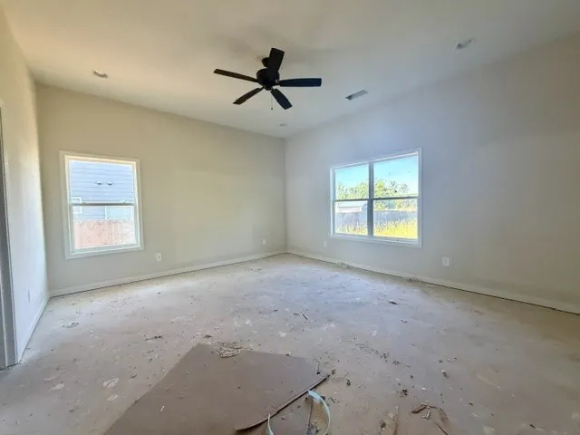 An airy bedroom awaits personalization, offering abundant natural light and a ready canvas.