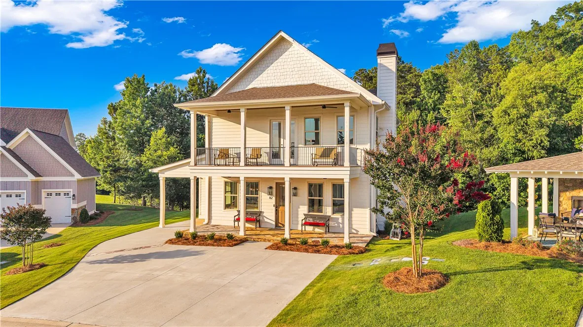 A charming cottage-style residence with multiple balconies and inviting curb appeal.