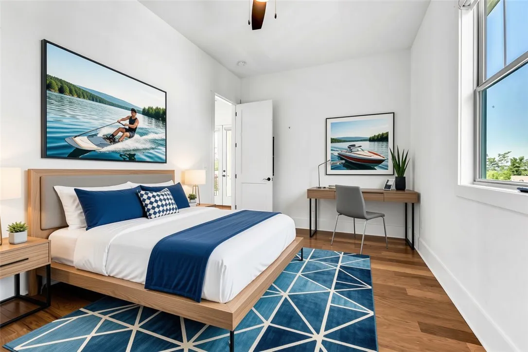 Bright hardwood floors and a modern rug enhance this cozy sleeping sanctuary.