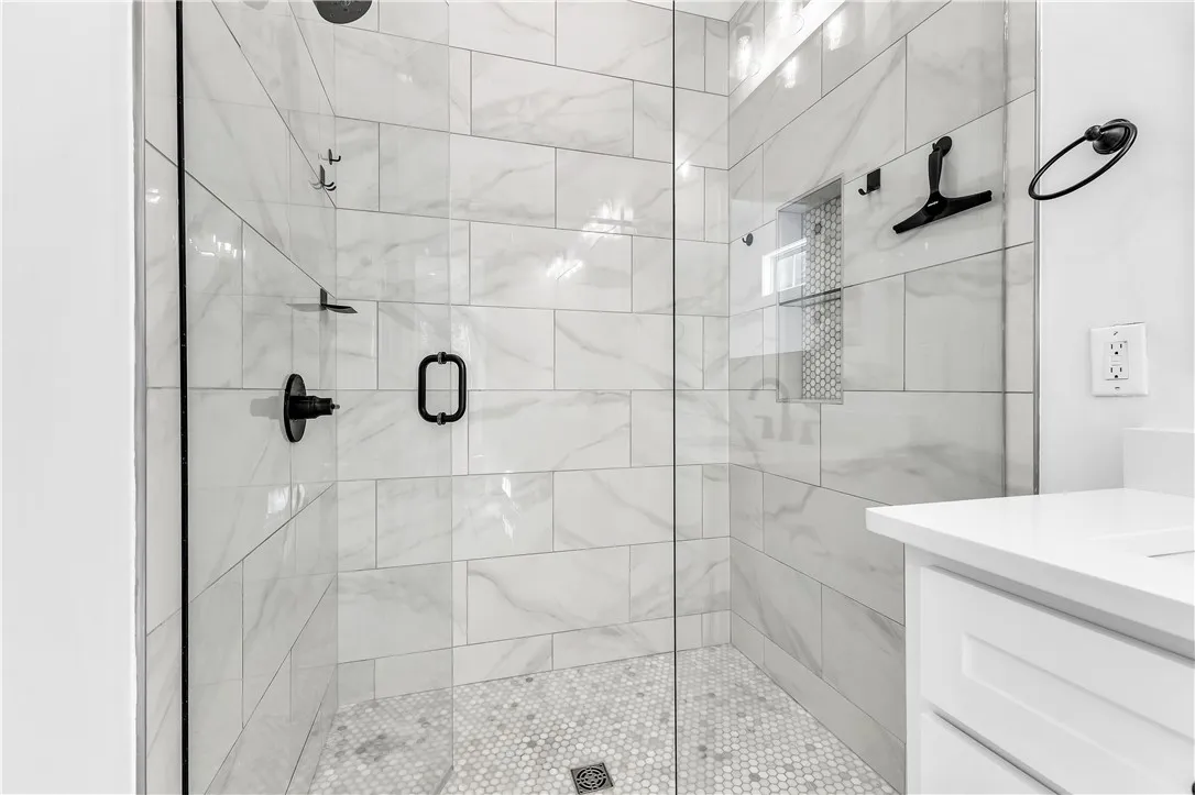 A well-appointed shower stall features sleek tiling and a modern glass enclosure.