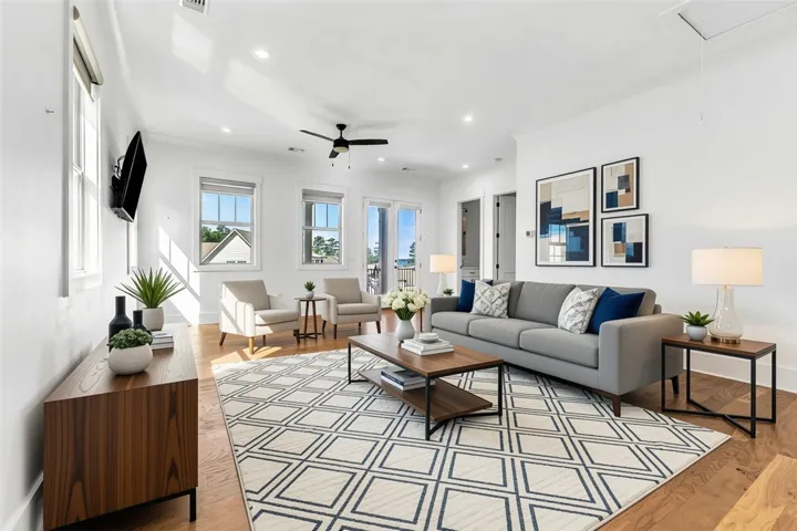 Hardwood floors and bright walls create an inviting, open atmosphere in this living room.