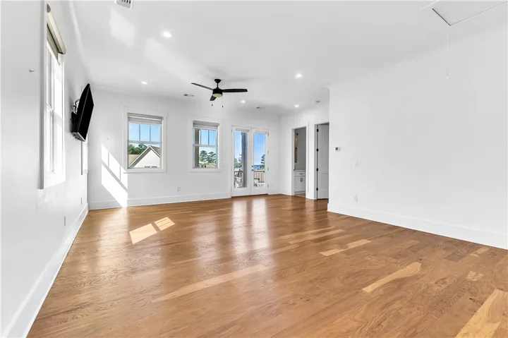 Hardwood floors and a private balcony enhance this inviting living space.