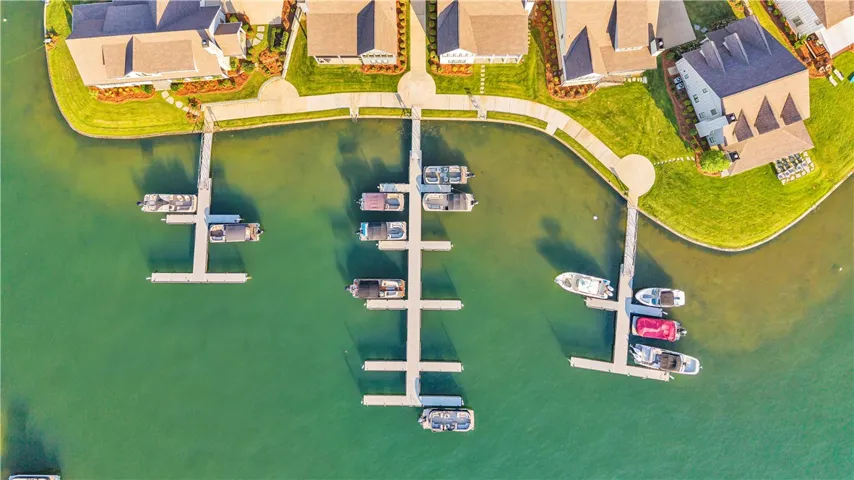 Aerial view showcasing prime waterfront properties with private boat docks along a serene canal.