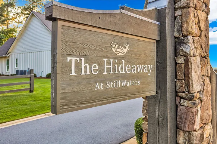 Stone and wood accents welcome residents to "The Hideaway at StillWaters" community.