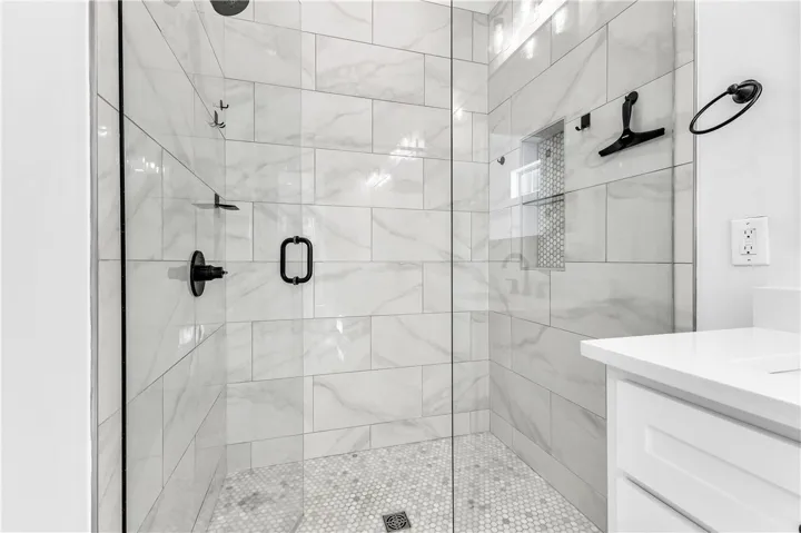 A well-appointed shower stall features sleek tiling and a modern glass enclosure.