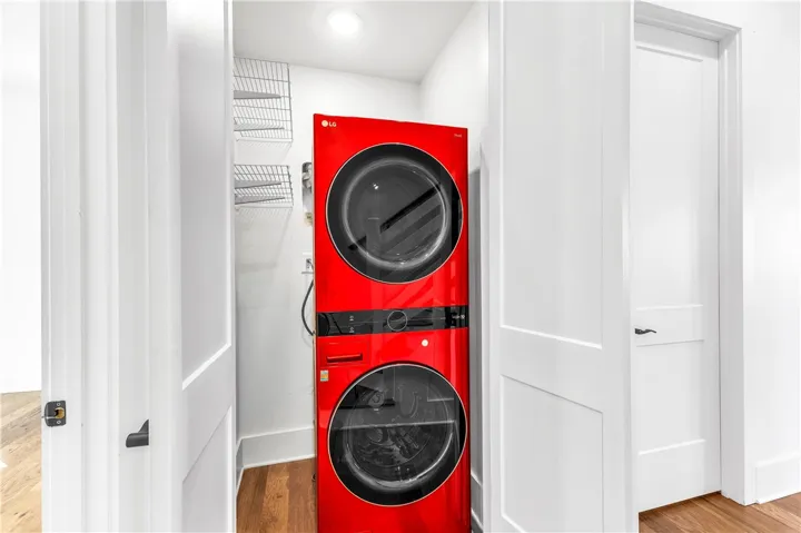 A vibrant red stackable washer and dryer unit, conveniently tucked away for seamless integration into any home.
