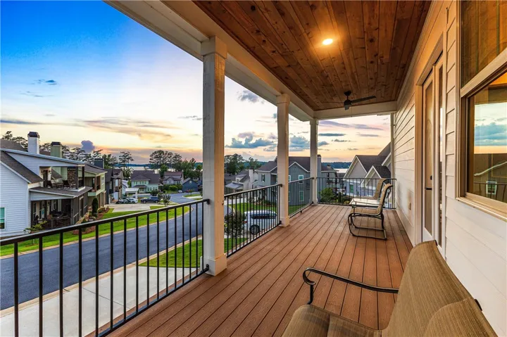 Unwind on this spacious balcony overlooking a serene lake and vibrant neighborhood.