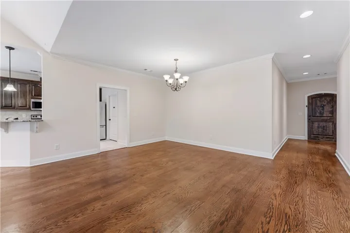Rich hardwood floors flow through this welcoming space, crowned with elegant crown molding.