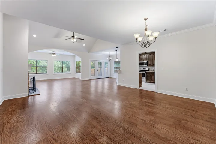 Rich hardwood floors unite the open living spaces, offering a welcoming flow to this bright interior.