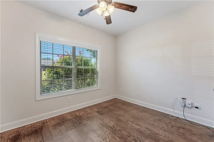 Hardwood floors and a bright window create an inviting atmosphere.