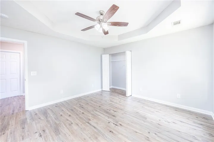 A well-lit bedroom with ample space and modern flooring awaits your personal touch.